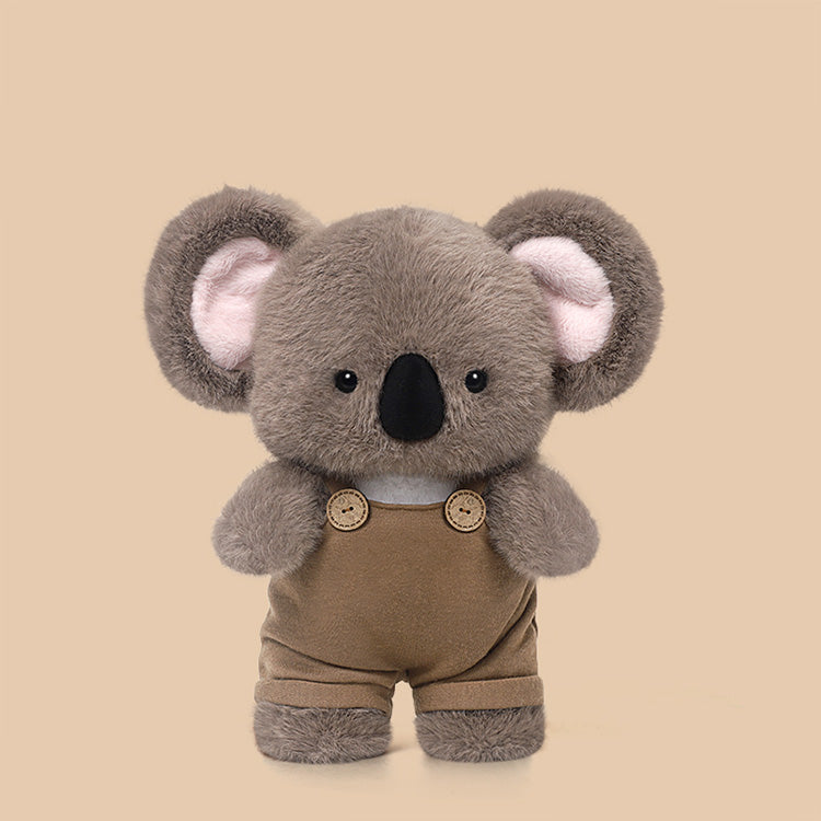Peluche koala Kooty con salopette marrone su fondo beige